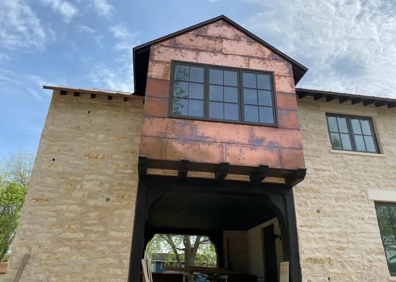 Copper metal panel facade on a stone building for Roof Repair in New Iberia